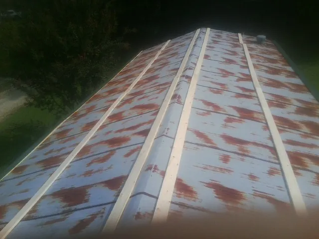 Rusted metal roof panels with new wood purlins before replacement — Storm Damage Roof Repair in Vero Beach by Roofing Brothers